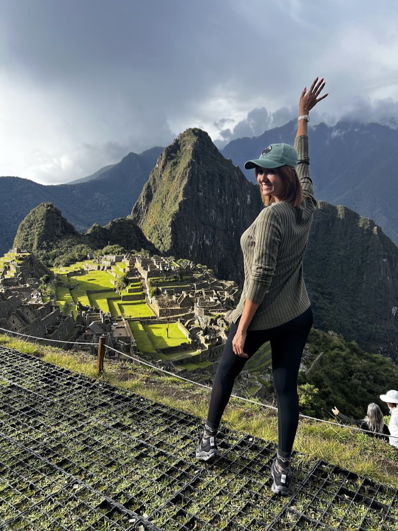 Gaudy, your Pecari Rides host, smiling and waving on a mountain adventure